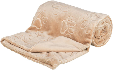 Beige Decke mit aufgedruckten Pfotenmustern, teilweise aufgerollt, weiches Material.