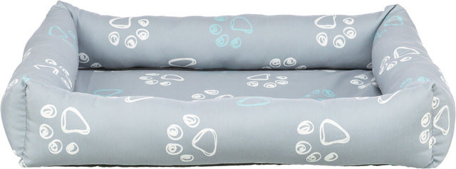 Graues Tierbett mit weißen und hellblauen Pfotenabdrücken auf weicher, gepolsterter Fläche.