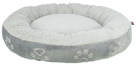Rundes, flauschiges Tierbett in hellem Grau und Weiß mit Pfotenabdruckmuster auf der Außenseite.