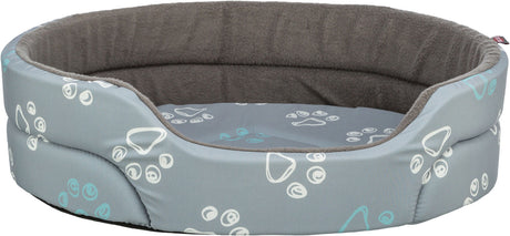 Graues, ovales Tierbett mit weißen und blauen Pfotenabdrücken und weichem, dunkelgrauen Innenfutter.