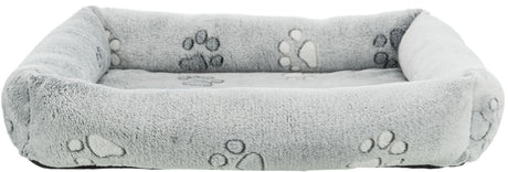 Graues, rechteckiges Plüschbett mit Pfotenmuster an den Seiten und auf der Liegefläche.