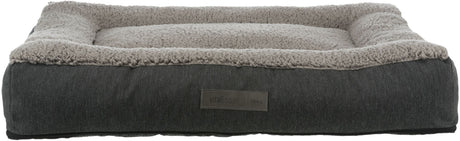 Rechteckiges Hundebett mit grauem Stoffbezug und flauschiger, heller Liegefläche, Label „vital Edition“.