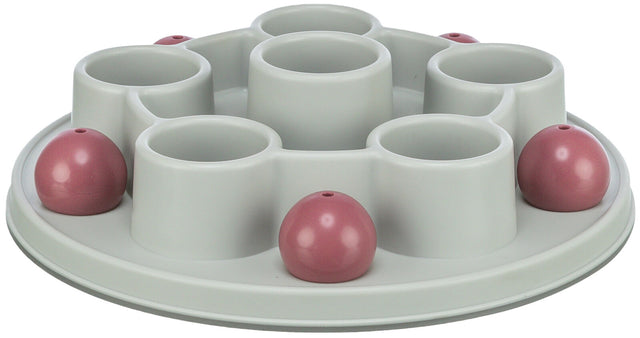 Runder, hellgrauer Kunststoffbehälter mit mehreren vertieften Fächern und rosa Kuppeln auf einer ebenen Oberfläche.