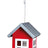 Rotes, hausförmiges Vogelhaus mit silbernem Dach und Aufhängeschlaufe, auf Metallboden befestigt.