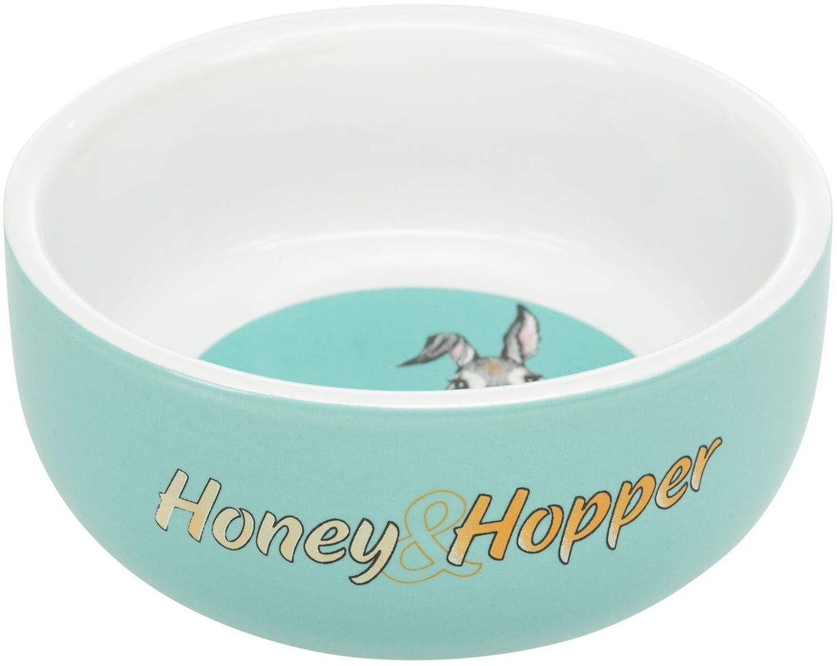 Türkise Schale mit weißem Rand und "Honey &amp; Hopper"-Aufschrift, innen ein Bild mit Tierohren.