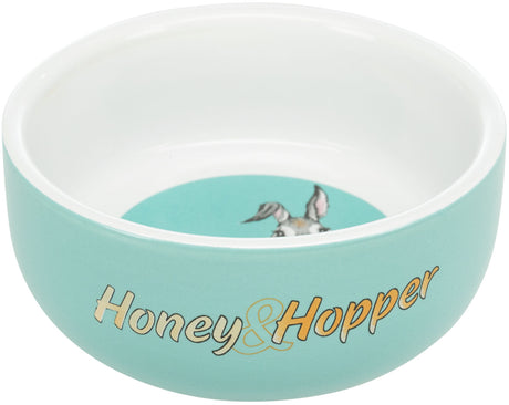 Türkise Schale mit weißem Rand und "Honey &amp; Hopper"-Aufschrift, innen ein Bild mit Tierohren.