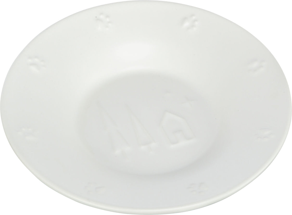 Weiße, runde Keramikschale mit geprägten Stern- und Hausmotiven sowie Pfotenabdrücken am Rand.