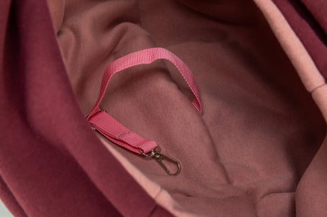 Der Innenraum eines rosafarbenen Stoffs mit einer passenden Schlaufe und Haken ist sichtbar.