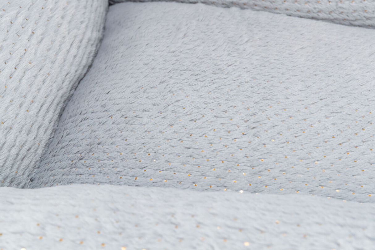 Grauer Stoff mit feinen, goldenen Punkten und weicher, texturierter Oberfläche.