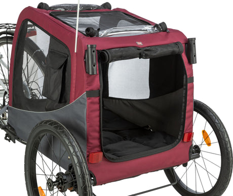 Roter und schwarzer Fahrradanhänger mit zwei Rädern und einem transparenten Dachfenster.