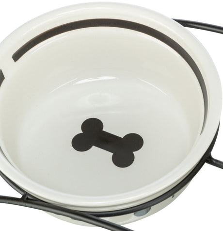 Weiße Futterschale mit schwarzem Knochenmotiv und Metallständer.