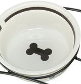 Weiße Futterschale mit schwarzem Knochenmotiv und Metallständer.