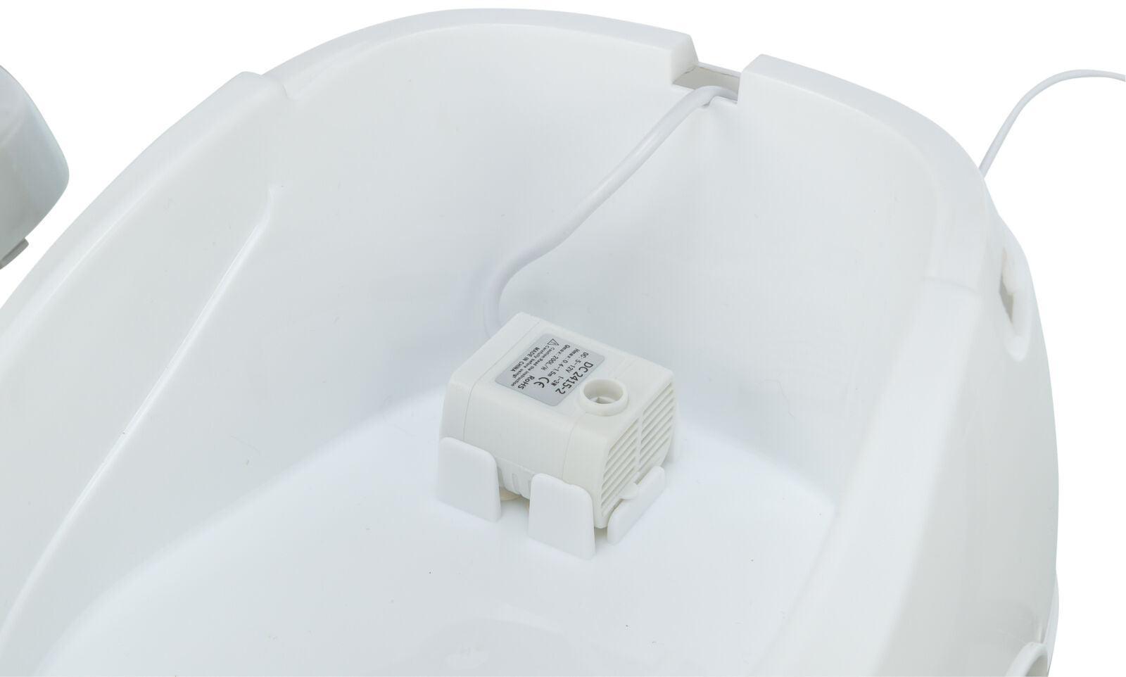 Weiße Kunststoffschale mit integriertem, beschriftetem elektrischen Modul und Kabel auf der Innenseite.