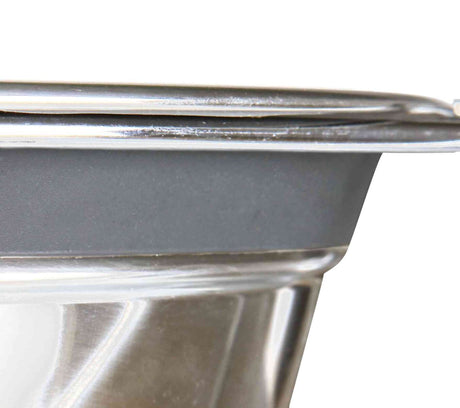 Silberne Metalloberfläche mit einer schwarzen, abgerundeten Kante am Rand.