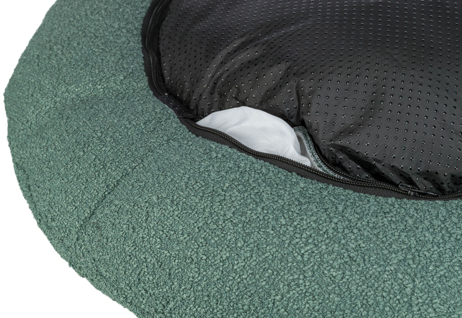 Grüne, runde Unterlage mit schwarzem gepunktetem Stoff und einem Reißverschluss, der weißen Stoff sichtbar macht.