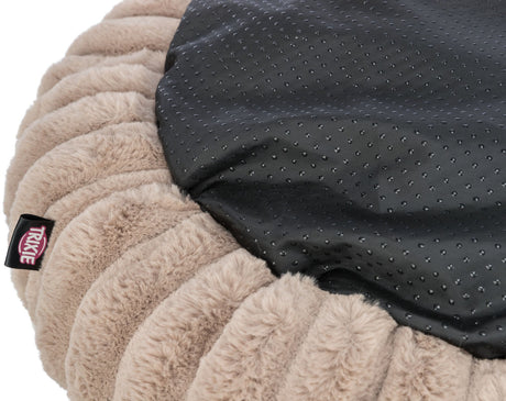 Plüschkissen mit beiger, gerippter Textur und schwarzer, genoppter Oberfläche, Label "Trixie" sichtbar.