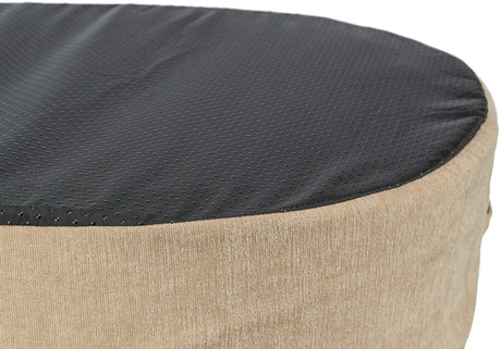 Runder Hocker mit beigefarbenem Stoffbezug und schwarzer, gepunkteter Oberfläche.