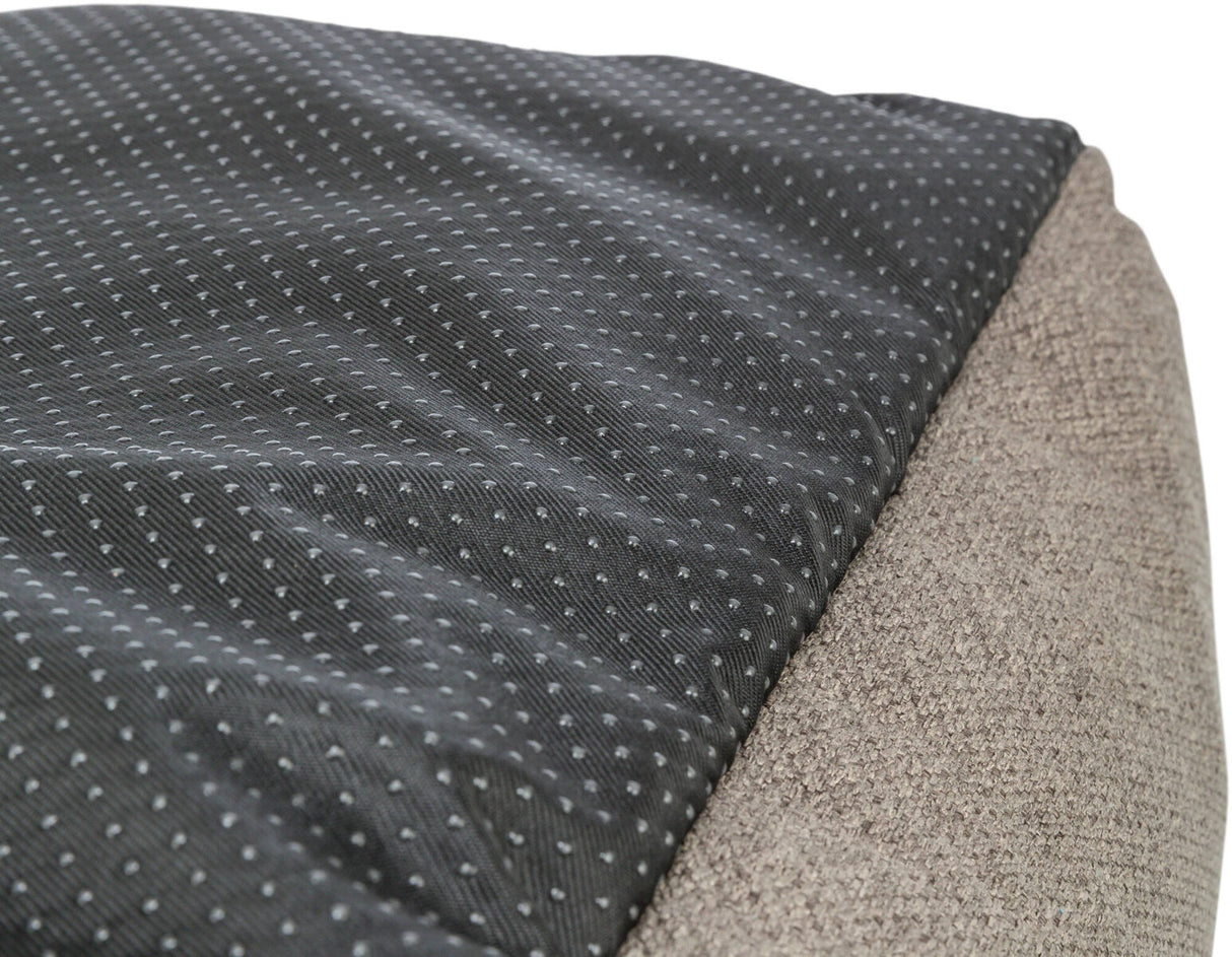 Grau gepunktetes, schwarzes Textilmaterial neben grob gewebtem, beigem Stoff.