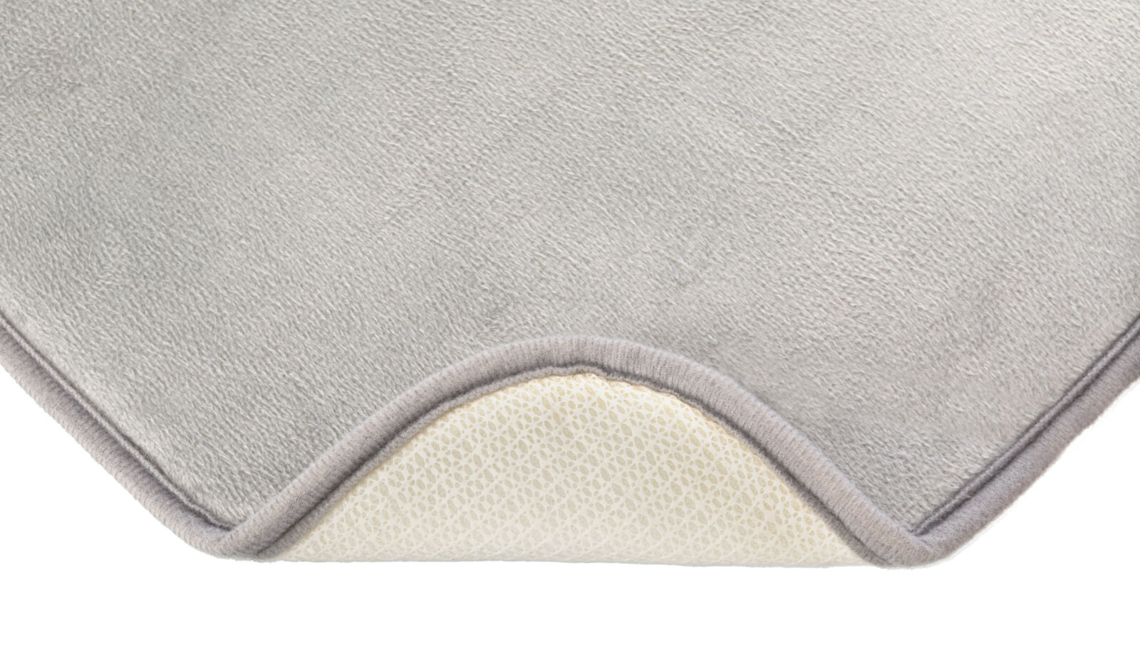 Graue Matte mit leicht texturierter Oberfläche und beigefarbenem Rand, untere Schicht in Creme mit perforiertem Muster.