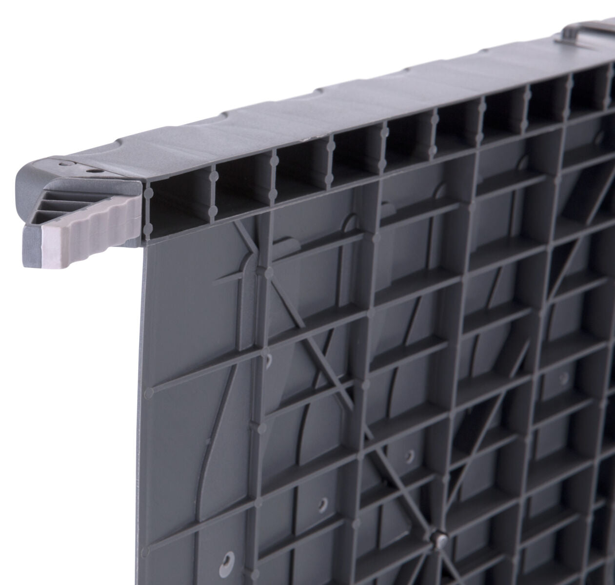 Graues, rechteckiges Kunststoffbauteil mit einer gerippten Oberfläche und zahlreichen Verstrebungen auf der Unterseite.