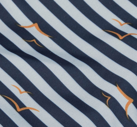 Stoff mit dunkelblauen und weißen Streifen sowie orangefarbenen Möwenmustern.