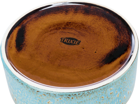 Keramikschale mit braunem Innenbereich und türkisem, gesprenkeltem Außenrand, Markenname "TRIXIE" sichtbar.